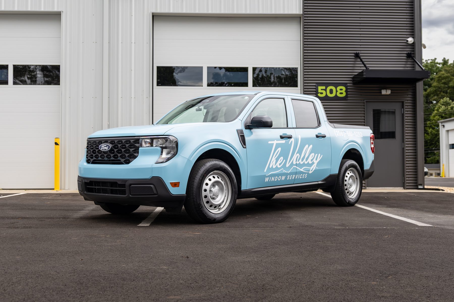 The Valley Window Services truck with a full color-change wrap and script logo installed by Good Graphics Co.