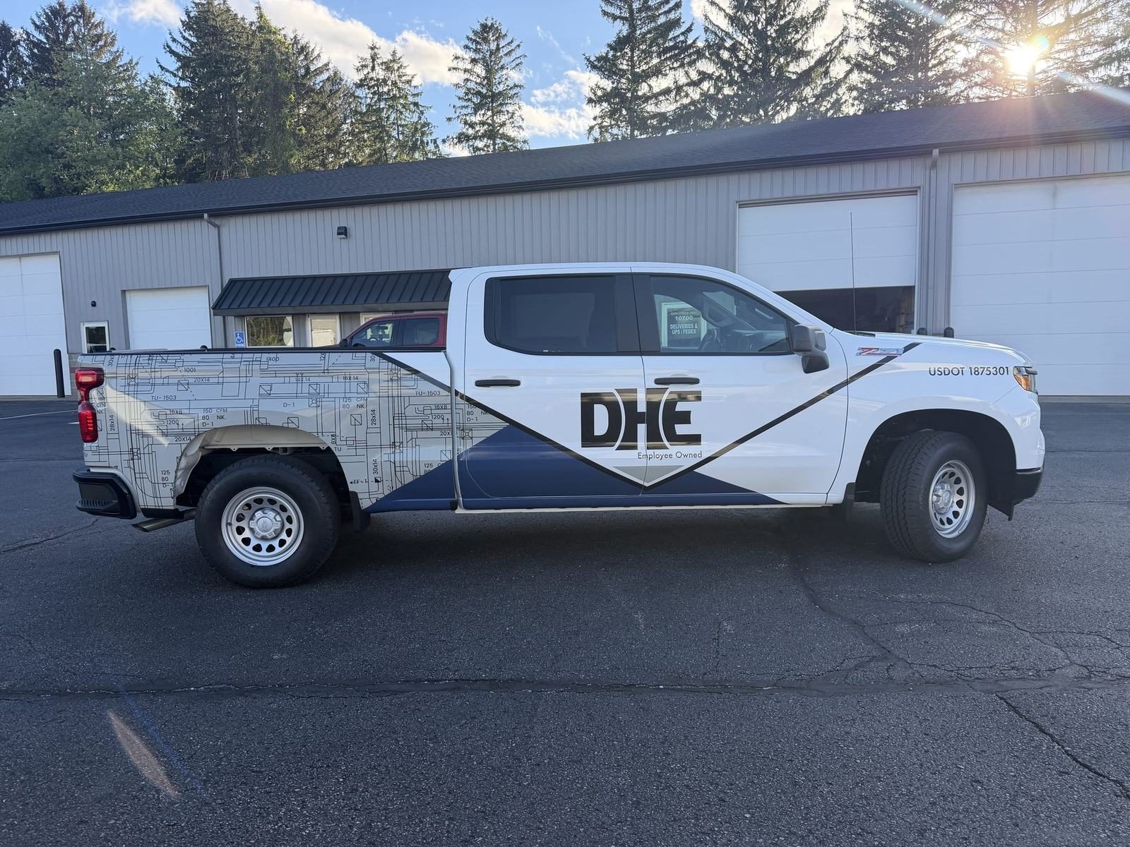 DHE fleet truck with full-coverage commercial graphics and USDOT numbering installed by Good Graphics Co.